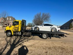 Flatbed Towing Truck Loaded With A White Car