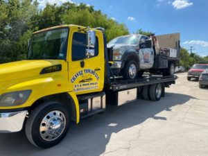 Commercial Service Car In A Flatbed Towing Truck