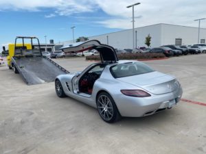 Loading Silver Sports Car In The Towing Truck