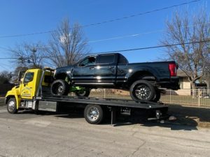 Flatbed Towing Truck Loaded With Black Car