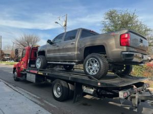 Flatbed Towing Truck Loaded With Chevrolet Truck