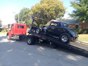 Towing Truck Loading A Black Volkswagen Car