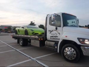 Green Sports Car In A Towing Truck