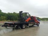 Flatbed Towing Truck Carrying A Forklift