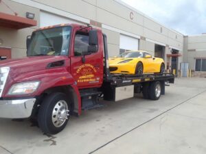 Chavez Towing Truck Loaded With Yellow Sports Car