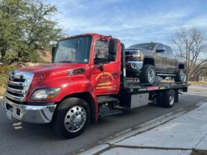 Red Chavez Towing Truck Loaded With Ram Car