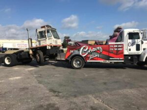 White Chavez Towing Truck Towing White Truck