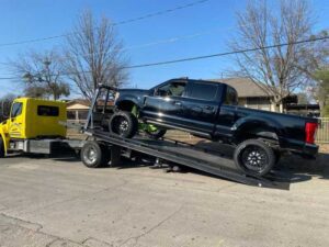 Yellow Chavez Towing Truck Loading Black Car