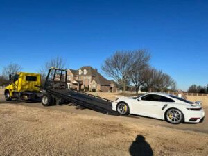 Yellow Chavez Towing Truck Loading White Porsche Sports Car