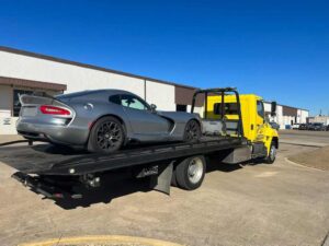Yellow Towing Service Loaded with Gray Luxury Car
