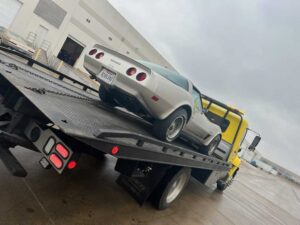 Yellow Towing Truck Loaded With Gray Car